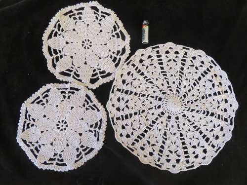 Three ecru-coloured crochet doiles