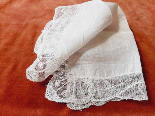 Delicate, white lace handkerchief / hanky - small tear