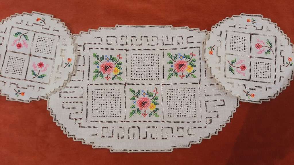 Embroidered doilie mats with cross stitch flower motifs