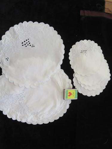 Set of 9 small white embroidered doilies