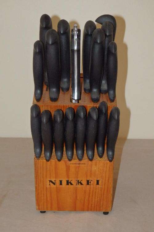 AN AMAZING NIKKEI KNIFE SET IN A WOODEN HOLDER THAT INCLUDES A CLEAVER, SHEARS AND MANY KNIVES