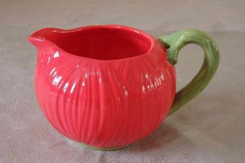 A GORGEOUS TOMATO RED CERAMIC MILK JUG WITH A GREEN HANDLE IN STUNNING CONDITION