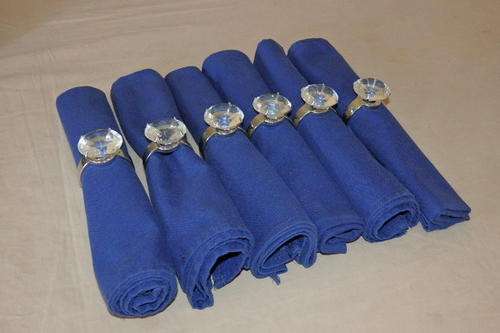 AN EXQUISITE SET OF 6 SILVER PLATED SERVIETTE RINGS WITH "HUGE" DIAMOND CUT CRYSTALS & 6 SERVIETTES