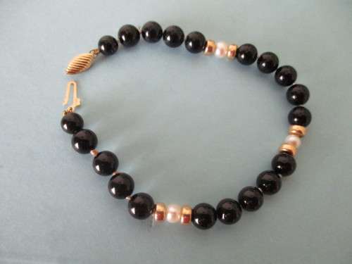 14 ct Gold Clasp, 14k gold spaces, cultured peals and  Black Onyx Bracelet