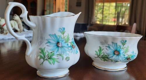 Delightful Royal Albert Marguerite cream and sugar with blue daisies.