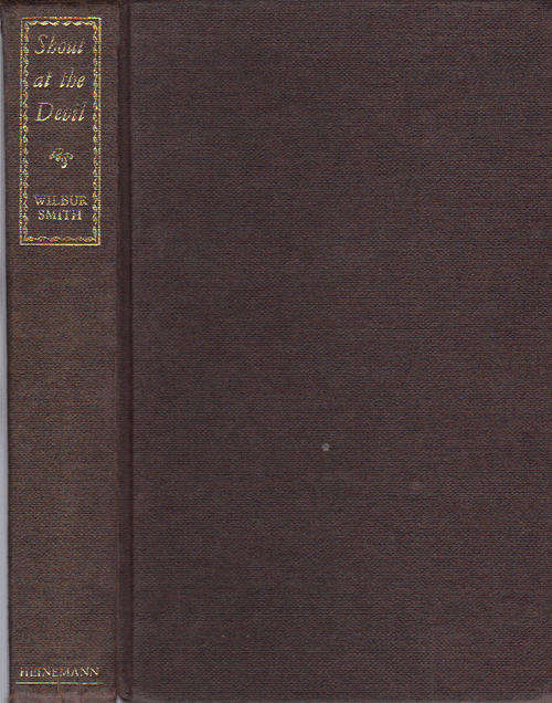 SHOUT AT THE DEVIL - Wilbur Smith - HARD COVER FIRST EDITION