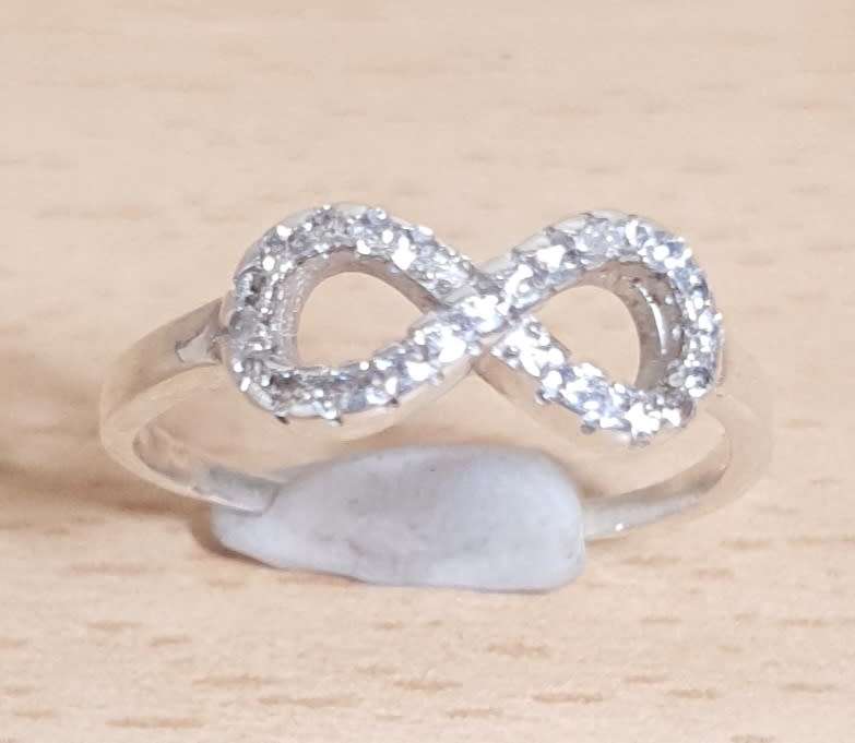 Brand new Ladies Infinity Hallmarked 925 Italy Sterling Silver Dress Ring with CZ stones.