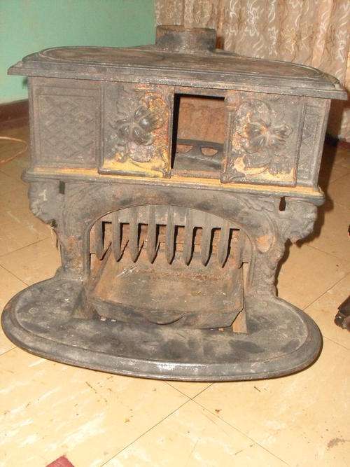 VINTAGE CAST IRON STOVE WITH SLIDING DOORS