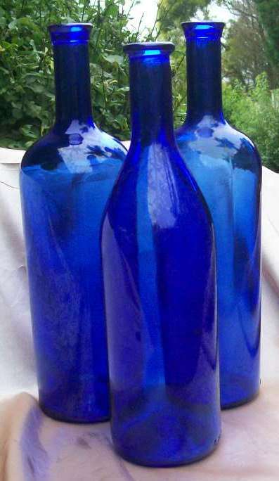 THREE BLUE GLASS BOTTLES