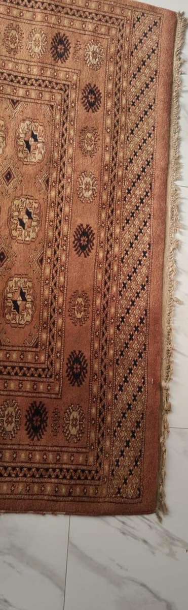 Slightly worn Persian carpet