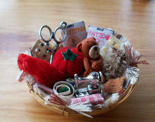 Miniature sewing basket with tiny bear.