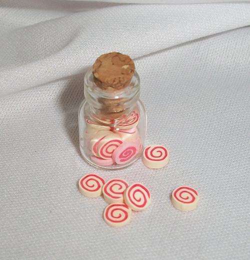 Miniature sweets in jar, swirls