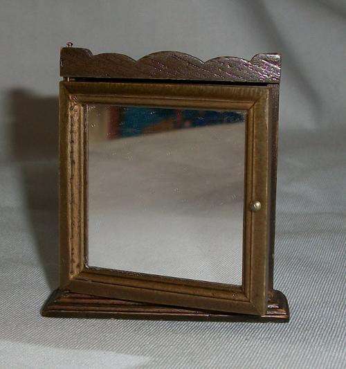 Bathroom cabinet with shelves and mirror.