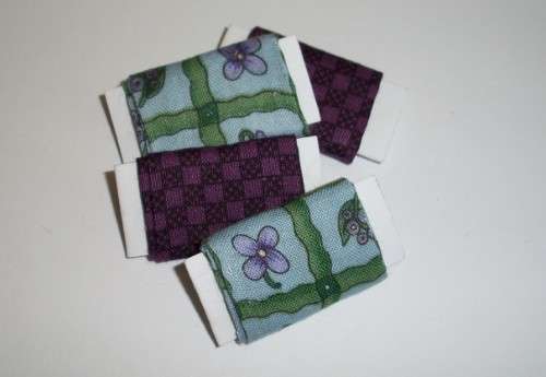Miniature rolls of fabric.