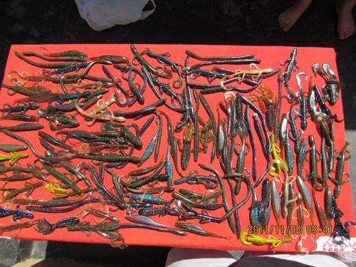 Assorted bass lures with PLANO case