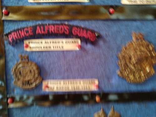 Display of South African Traditional Regiments cap/beret badges, shoulder titles and collar badges.