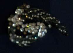 INTERESTING BLACK BROOCH DECORATED WITH SHINY STONES