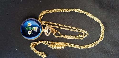 Miniature gold tone pocket watch on chain with blue enamel flower back