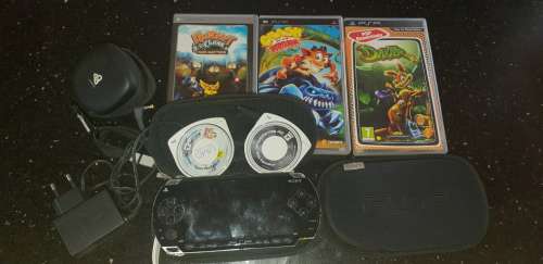 Sony Playstation portable (PSP) with 5 games and 2 pouches and adapter