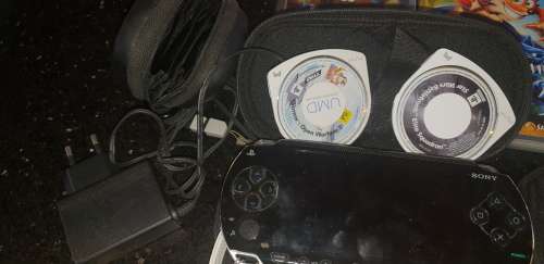 Sony Playstation portable (PSP) with 5 games and 2 pouches and adapter