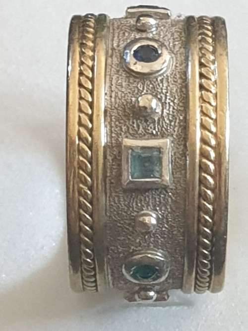 Broad 9ct yellow and white gold band ring with multicoloured stones