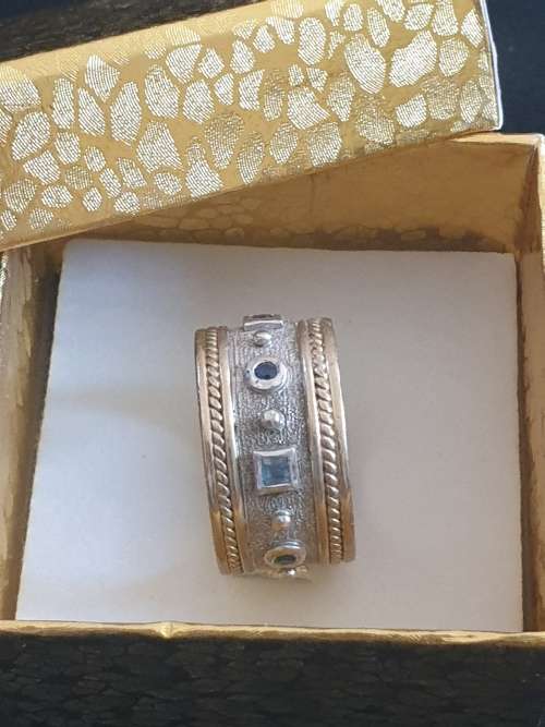 Broad 9ct yellow and white gold band ring with multicoloured stones