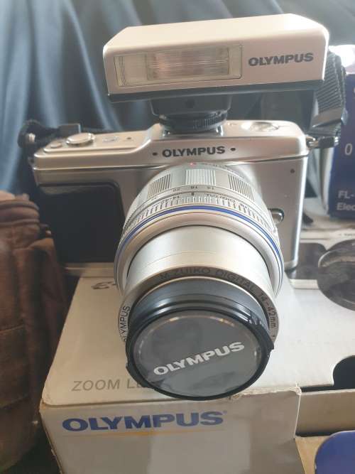 Olympus PEN E-P1 Digital Camera with interchangeable lenses and flash
