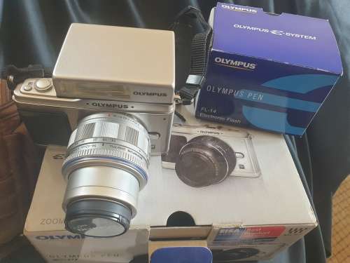 Olympus PEN E-P1 Digital Camera with interchangeable lenses and flash