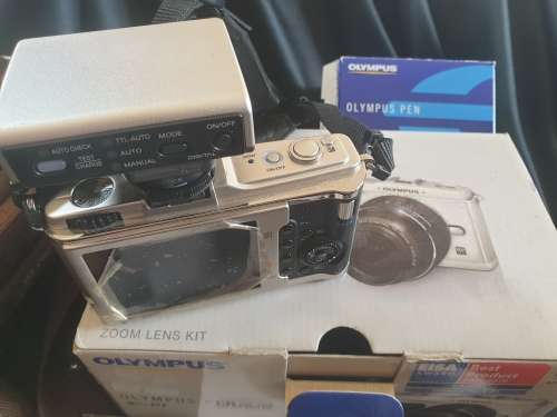 Olympus PEN E-P1 Digital Camera with interchangeable lenses and flash