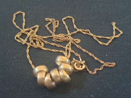 Delicate 9ct gold necklace with 7 friendship rings