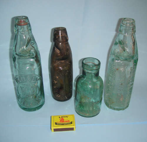 Four old Glass Bottles (three South African and one from England)