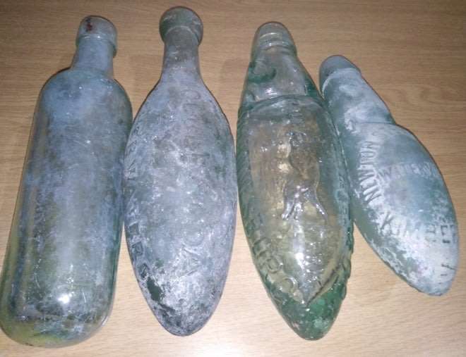 Four Vintage Bottles With a Round or Torpedo Base