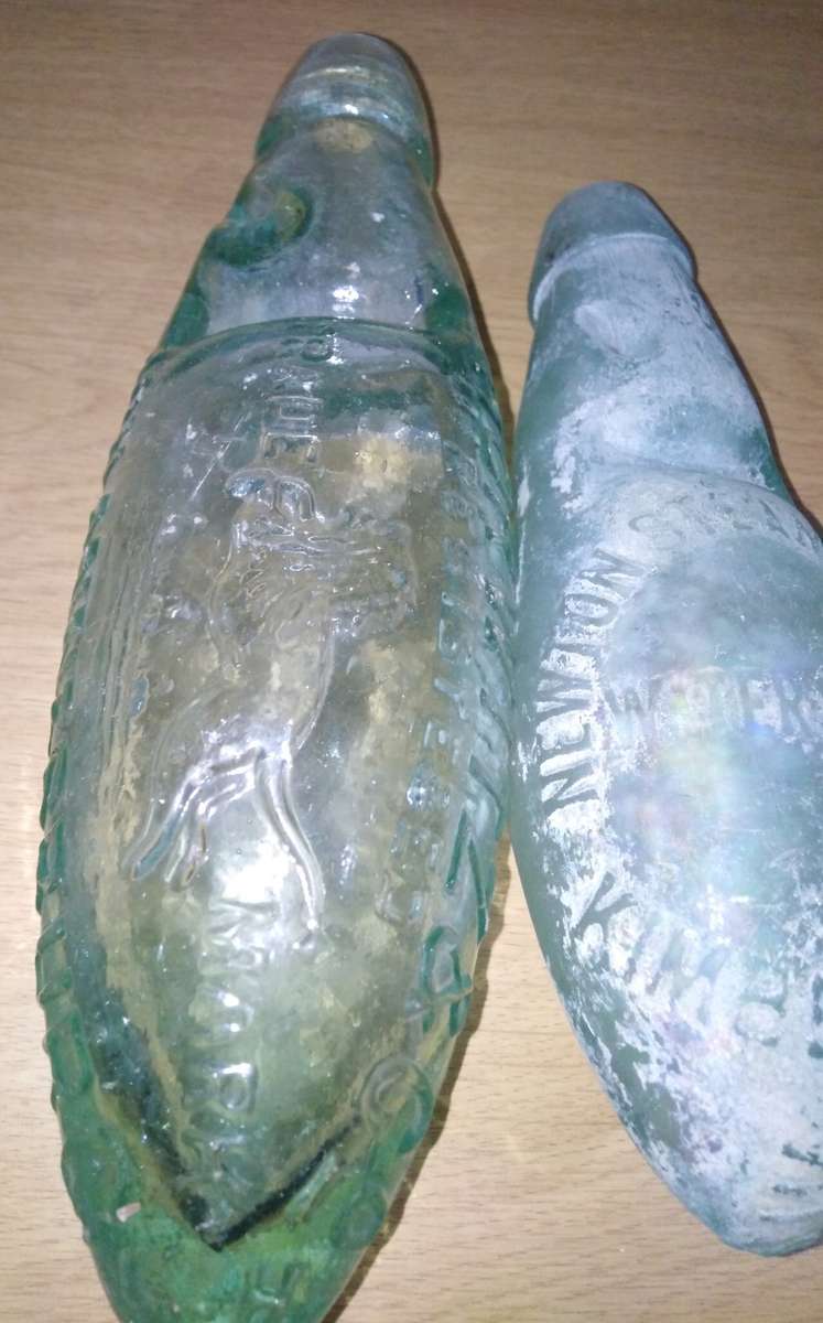 Four Vintage Bottles With a Round or Torpedo Base