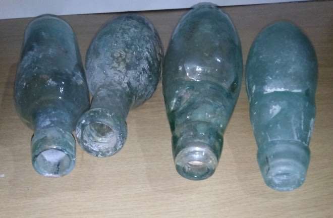 Four Vintage Bottles With a Round or Torpedo Base