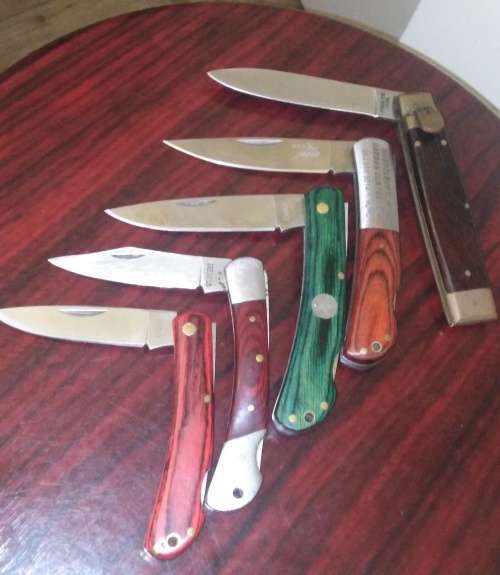 A Collection of 5 Folding Knives with Wooden Handles