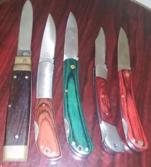 A Collection of 5 Folding Knives with Wooden Handles
