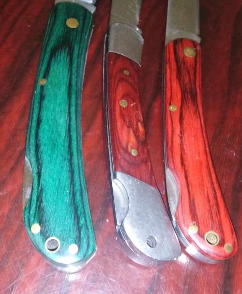 A Collection of 5 Folding Knives with Wooden Handles