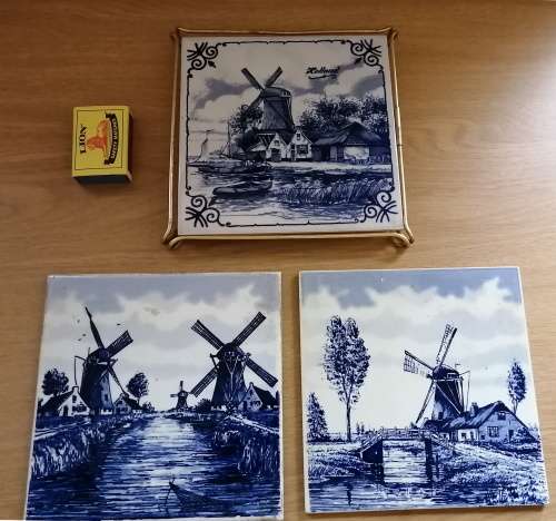 A Collection of three Delft tiles with windmill theme and one tile holder