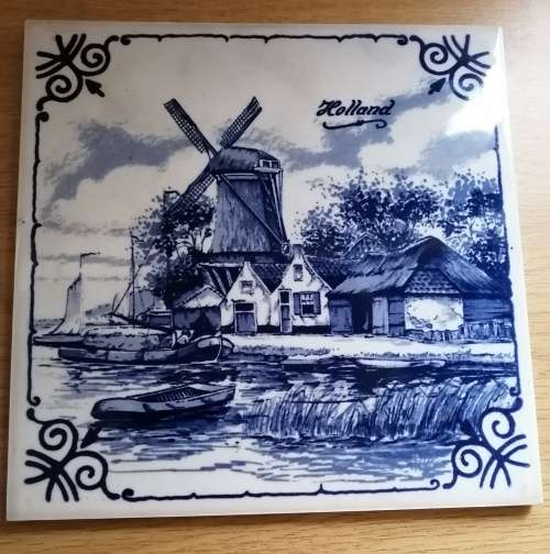 A Collection of three Delft tiles with windmill theme and one tile holder