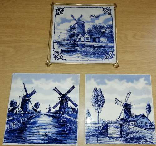 A Collection of three Delft tiles with windmill theme and one tile holder