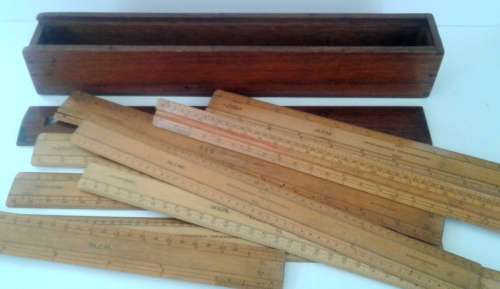 Vintage wooden box with assortment of rulers still in inches