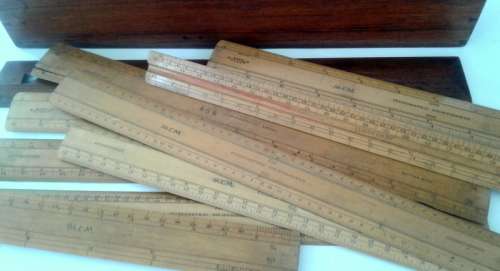 Vintage wooden box with assortment of rulers still in inches