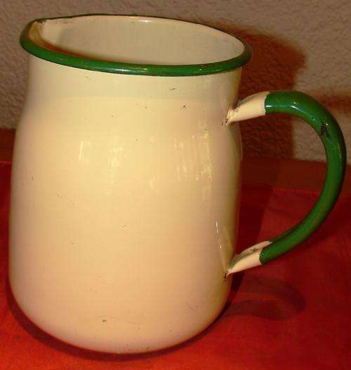 Vintage yellow enamel milk jug with green trimmings