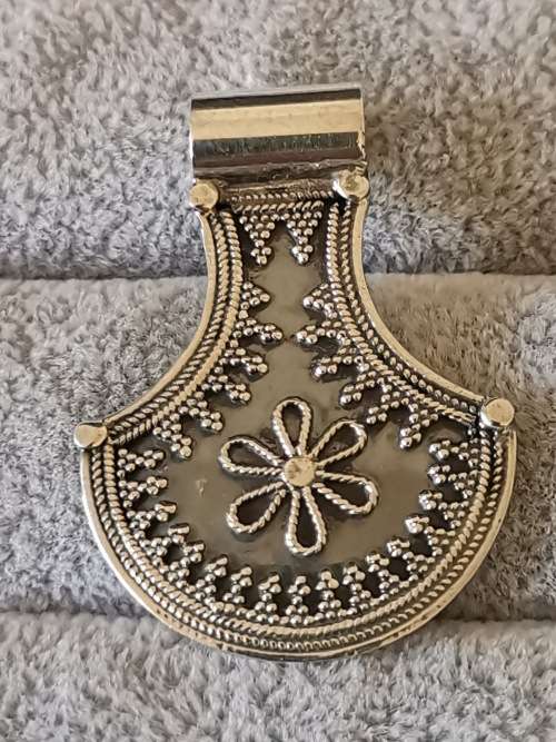 Silver pendant with intricate detailing