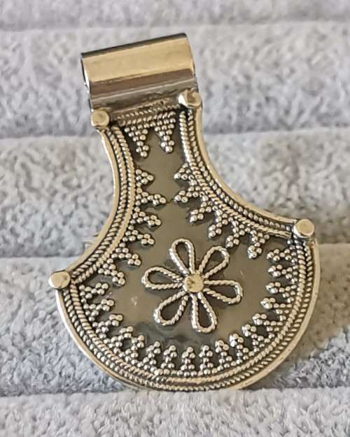 Silver pendant with intricate detailing