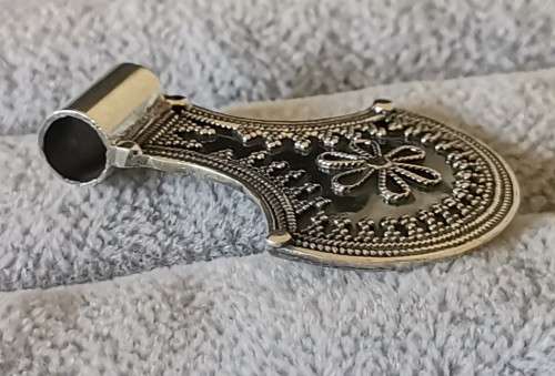Silver pendant with intricate detailing