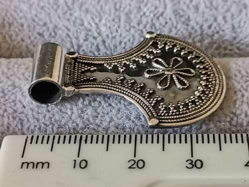Silver pendant with intricate detailing