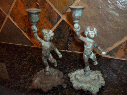 A PAIR  OF CHERUB METAL CANDLE STICKS