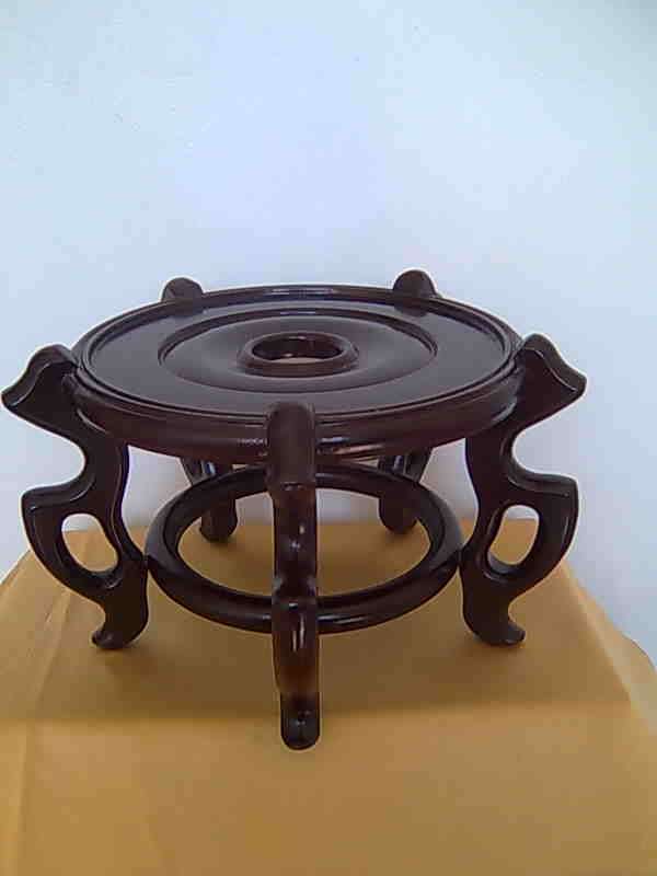 A WOODEN STAND FOR VASES AND BOWLS