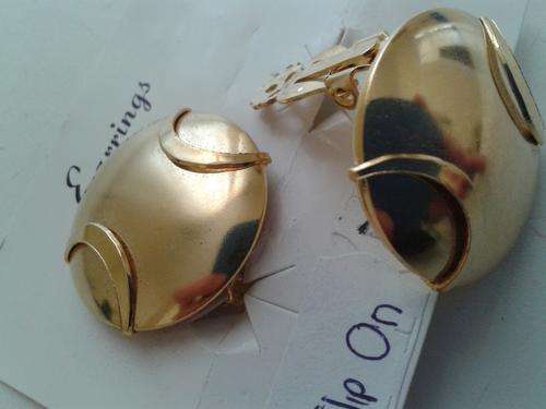 Clip on gold tone earrings. One bid for 2 sets.